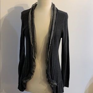 Gray cardigan sweater with light gray ruffle.